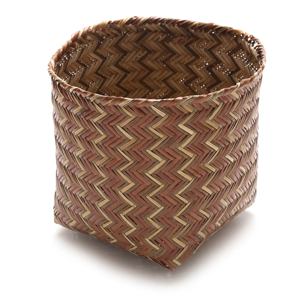 Woven basket with chevron pattern on a white background