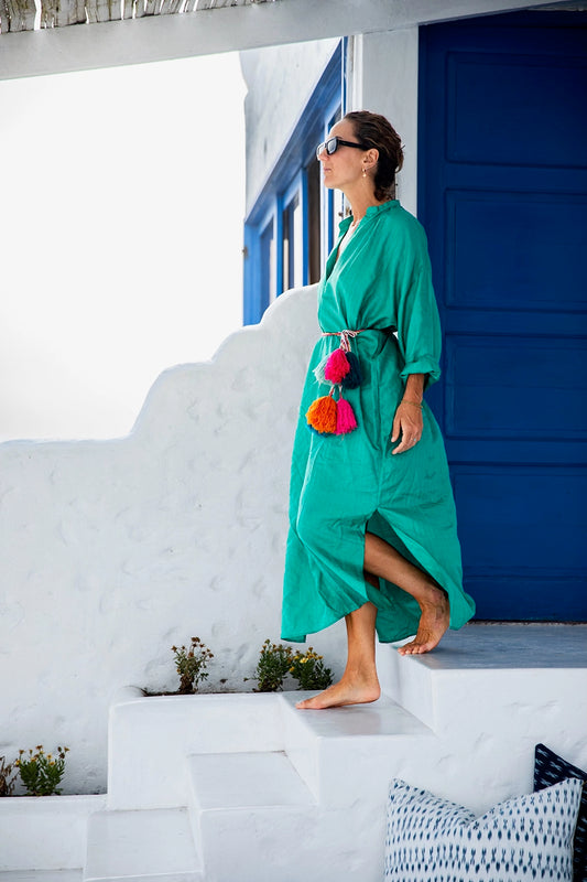 Traditional colorful Peruvian decorative tassel, handmade and one-of-a-kind, often used in festivals and celebrations on model walking in teal dress