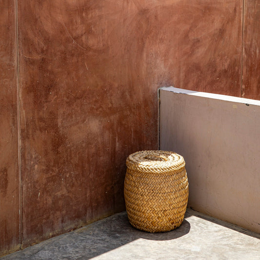 Woven basket against a wooden wall