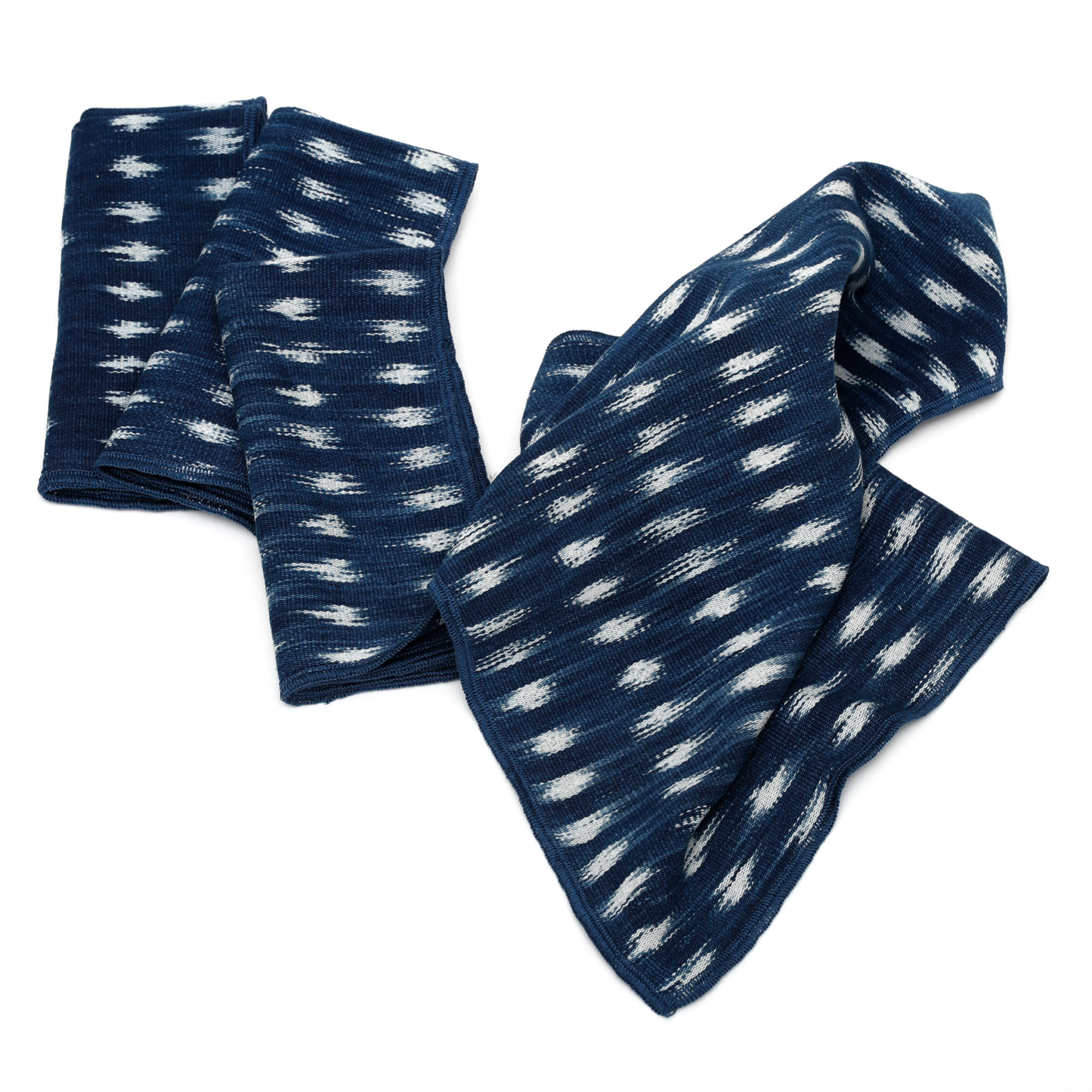 Peruvian ikat napkins in blue with a white geometric pattern.