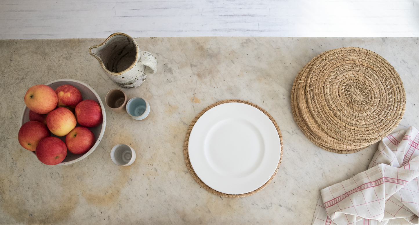 Intiearth natural fiber coiled placemat made from dried junco grass, offering a rustic yet elegant touch to your table setting.