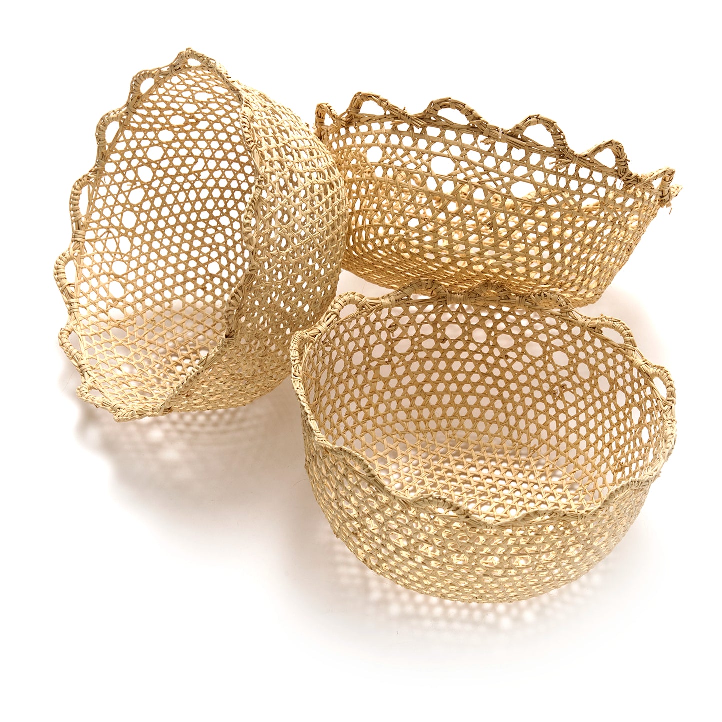 Three gold mesh baskets on a white background
