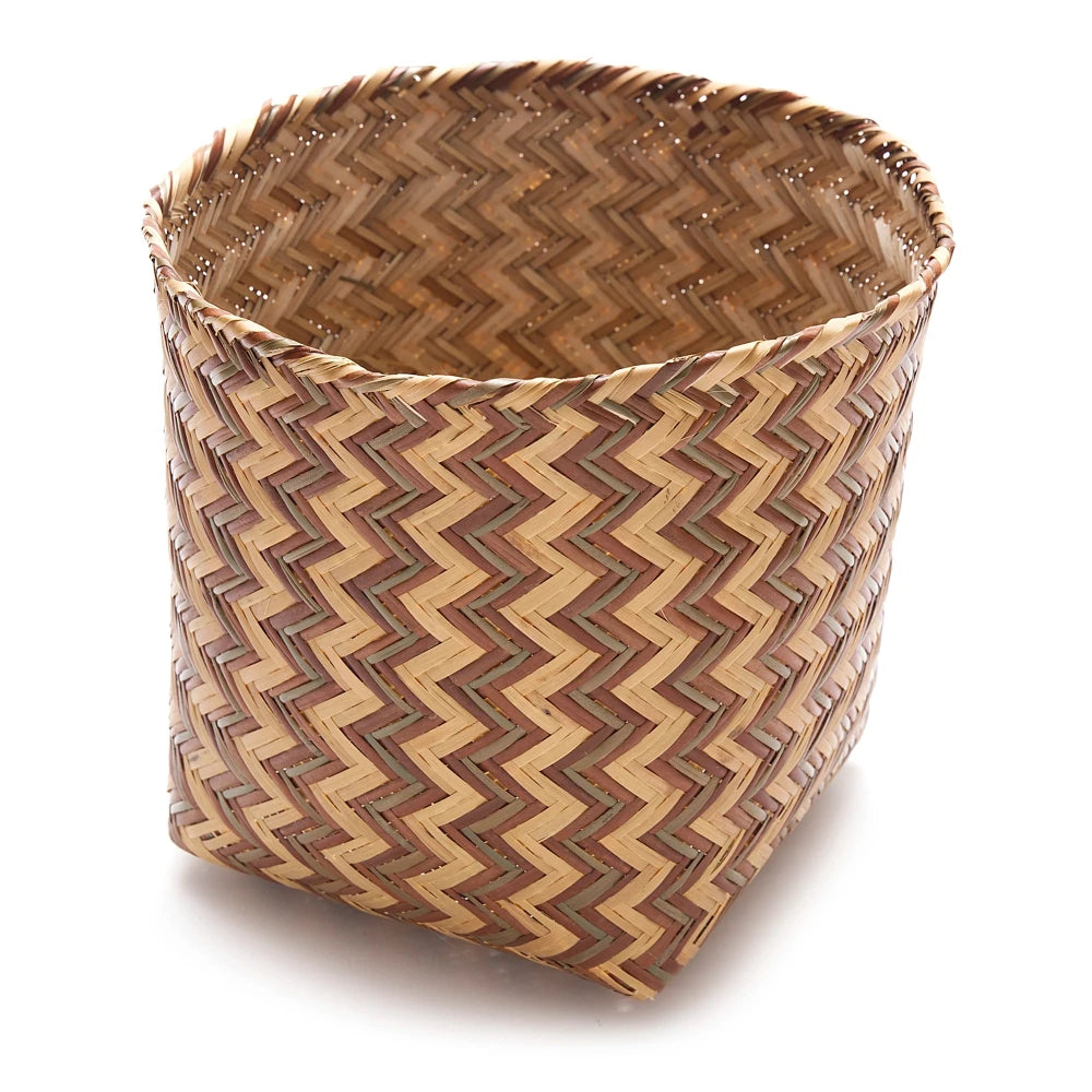 Woven basket with zigzag pattern on a white background