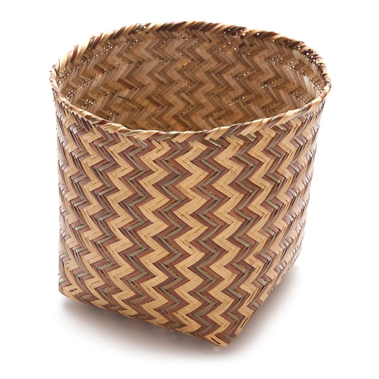 Woven basket with zigzag pattern on a white background