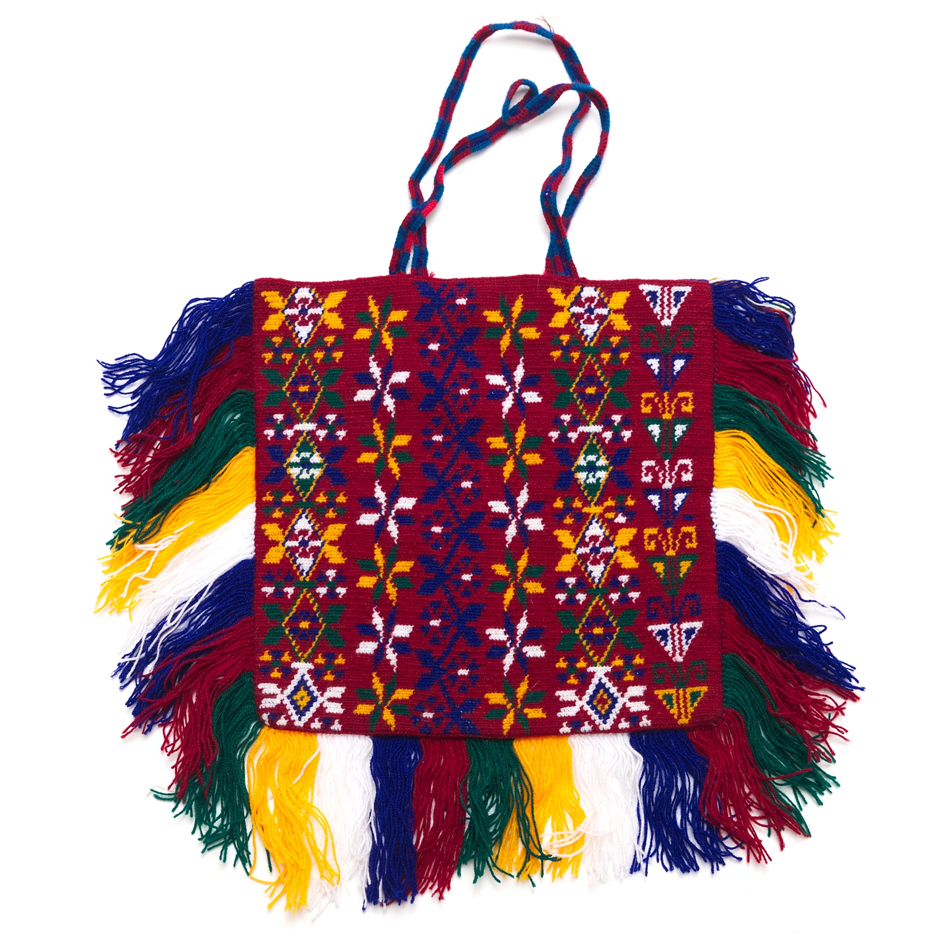 Colorful hand-woven bag with geometric patterns and fringes on a white background