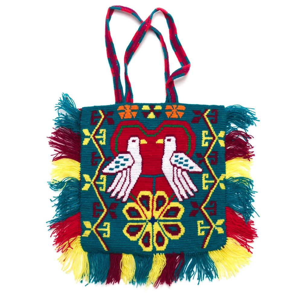 Colorful handbag with geometric patterns and fringes on a white background