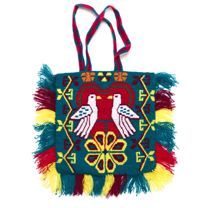 Colorful handbag with geometric patterns and fringes on a white background