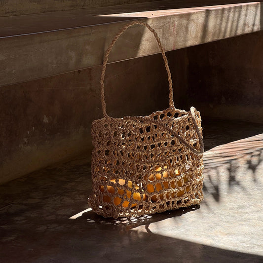 Intiearth Handwoven tote bag inspired by the ancient shicra style, made from natural fibers with an open weave pattern.