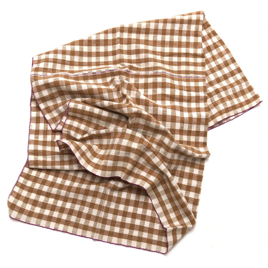 Brown and white checkered fabric on a white background