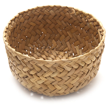 Woven basket with a herringbone pattern on a white background