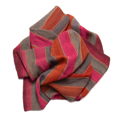 Striped frazada with pink, orange, and gray pattern on a white background