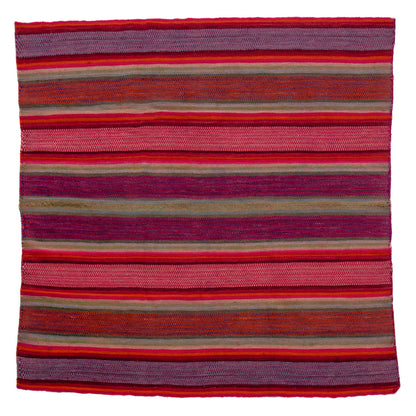 Striped fabric with red and purple hues on a white background