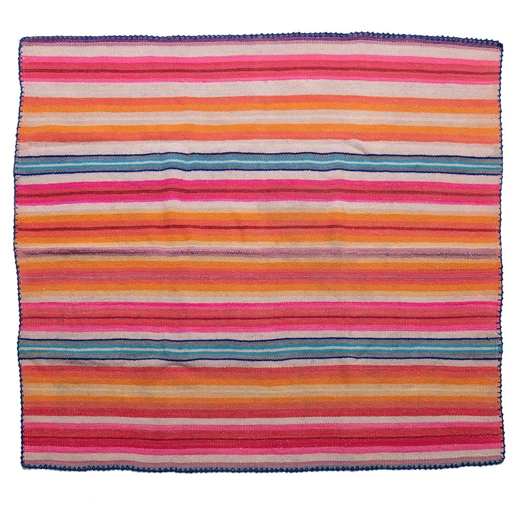Multicolored striped fabric with pink, orange, blue, and purple hues on a white background.