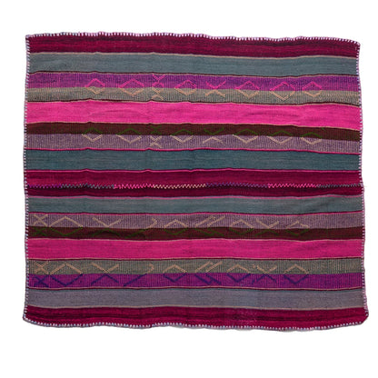 A square woven textile with horizontal stripes in pink, teal, purple, brown, and gray, featuring geometric diamond patterns and a fringed border, shown flat against a white background.