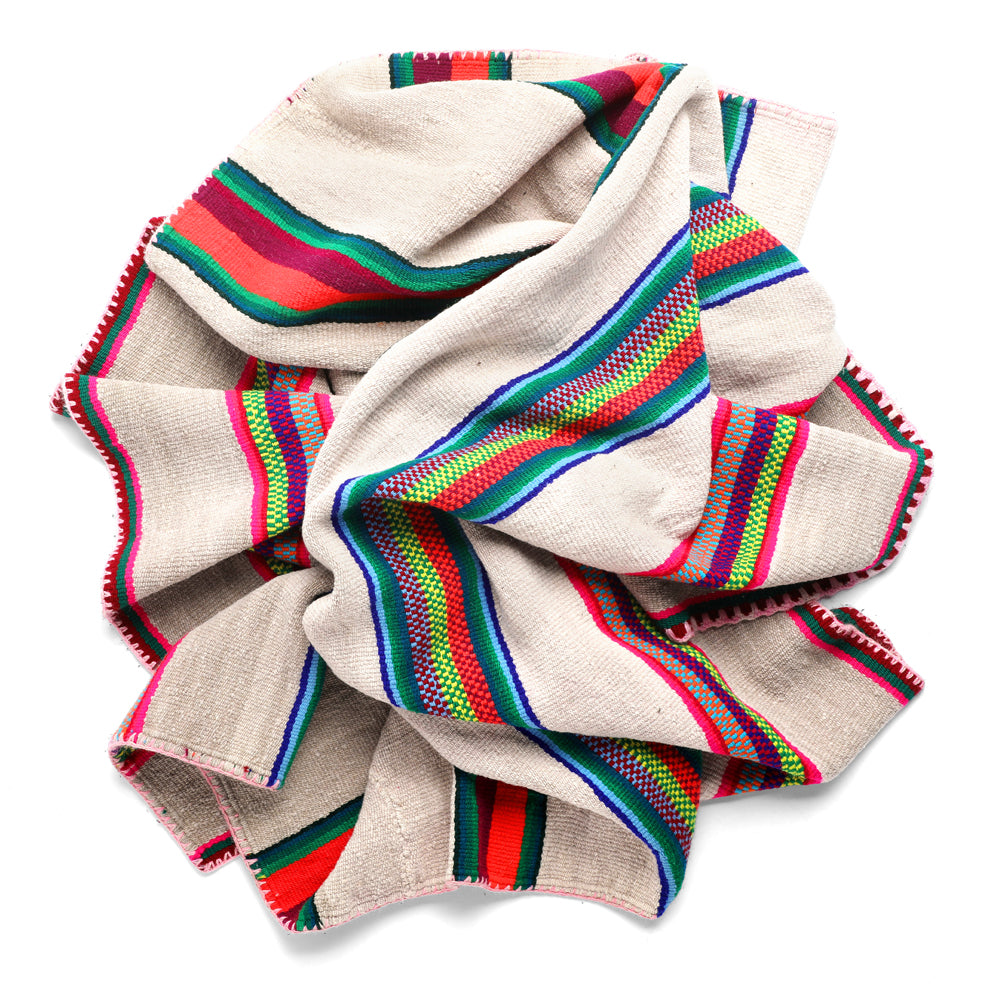 Intiearth vintage Peruvian Frazada textile with colorful geometric patterns and stripes. Traditional handwoven multipurpose textile from Peru, ideal for home décor, can be used as a blanket, rug, throw, or wall hanging. Made of handspun wool and crafted on a backstrap loom.