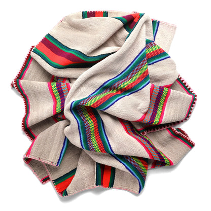 Intiearth vintage Peruvian Frazada textile with colorful geometric patterns and stripes. Traditional handwoven multipurpose textile from Peru, ideal for home décor, can be used as a blanket, rug, throw, or wall hanging. Made of handspun wool and crafted on a backstrap loom.