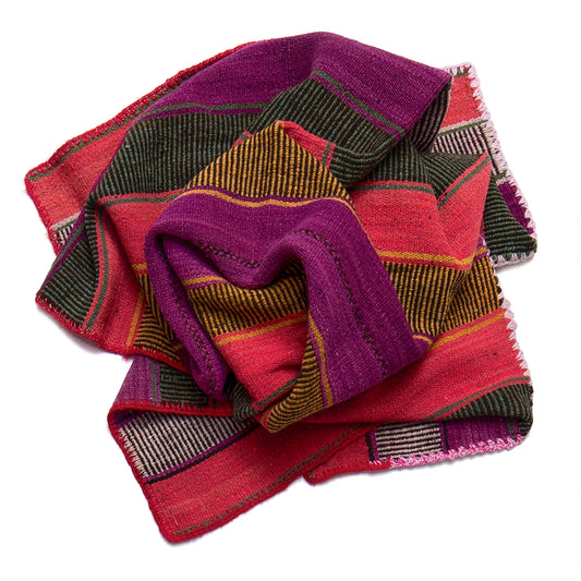Woven fabric with purple and red patterns on a white background