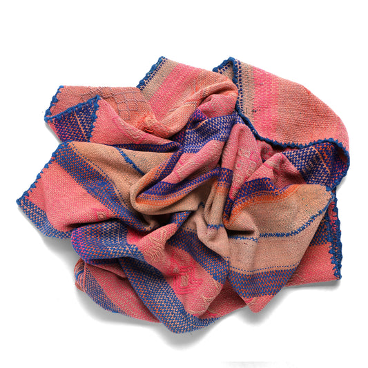 Woven fabric with pink and blue pattern on a white background