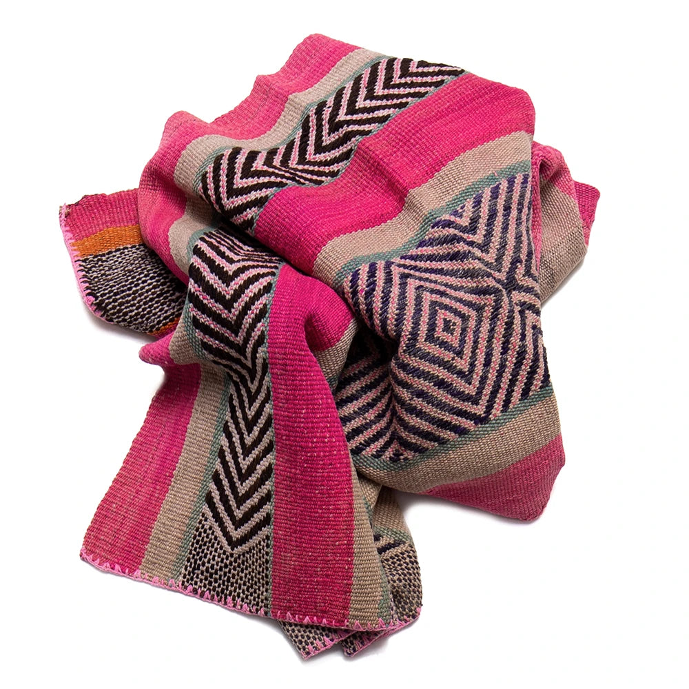 Woven textile with geometric patterns in pink, black, and orange on a white background