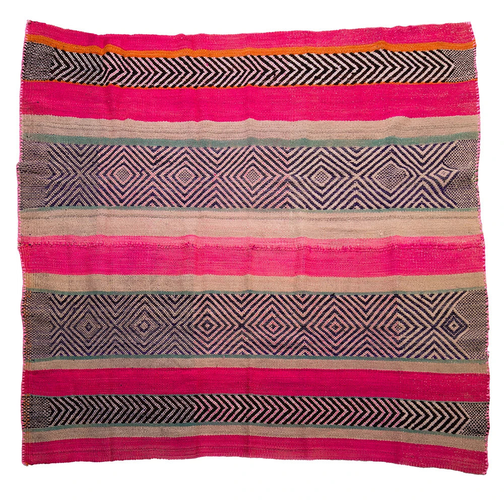 Woven textile with geometric patterns in pink, black, and beige on a white background