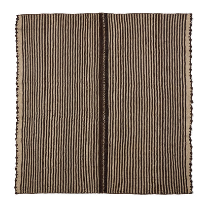 A square woven textile or rug with a vertical striped pattern in dark brown and beige, featuring fringed edges on all sides, shown flat against a white background.