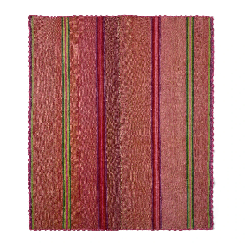 A square woven textile rug or mat with a warm rust-brown base and vertical stripes in pink, burgundy, green, and red, shown flat against a white background.
