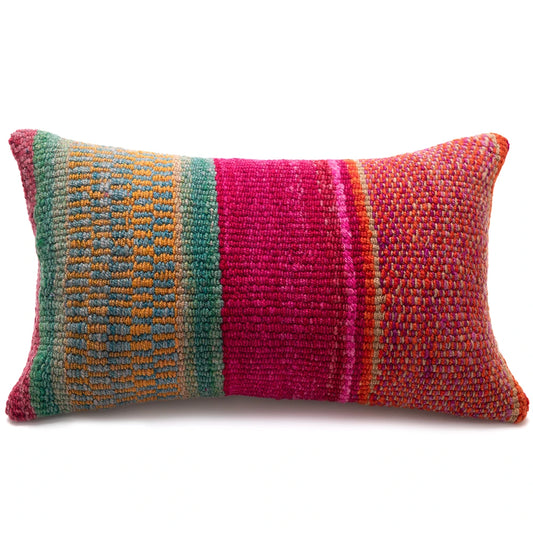 A rectangular handwoven lumbar pillow featuring vertical stripes of teal green, bright magenta pink, and orange-red with subtle multicolored yarn texture, shown on a plain white background.
