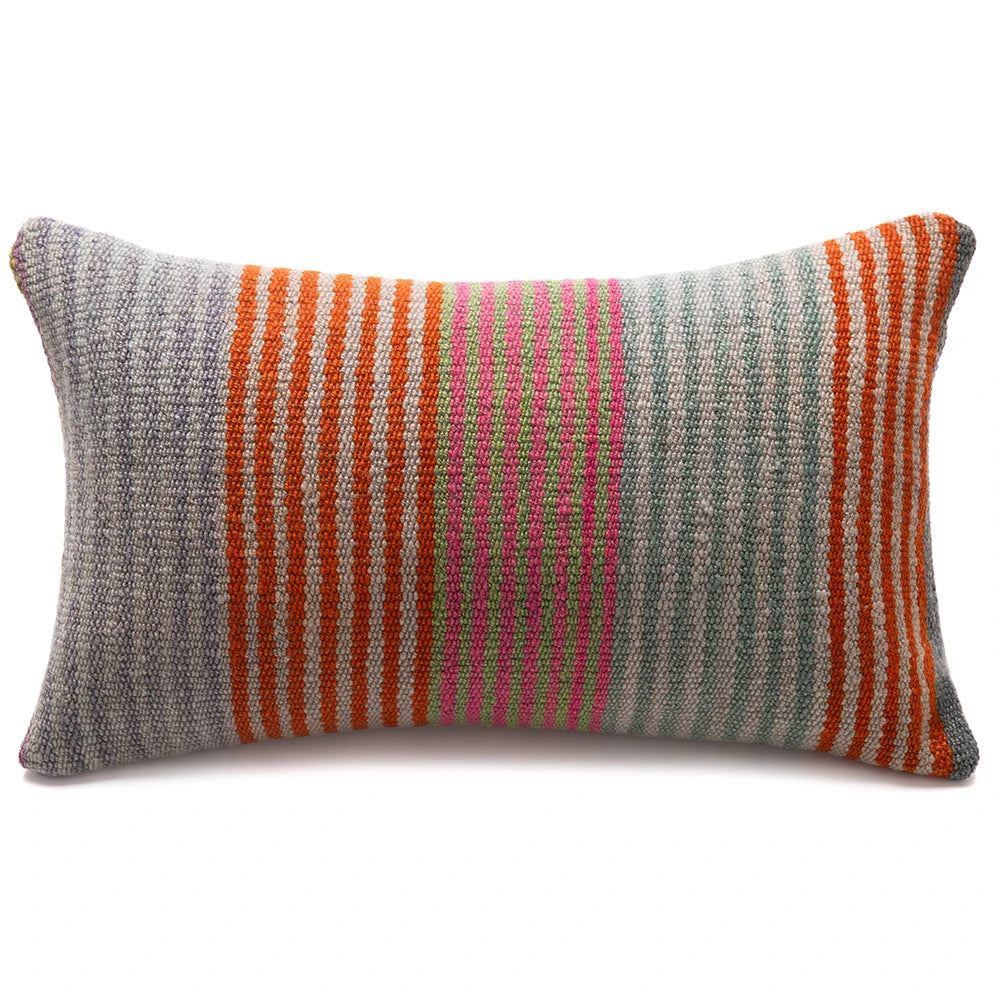 A rectangular woven lumbar pillow with vertical stripes in orange, pink, and green on a gray and white textured background, shown on a plain white background.