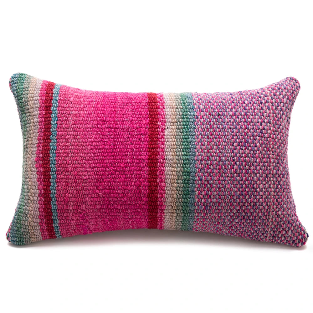 A rectangular woven lumbar pillow featuring a vibrant multicolor striped pattern with prominent pink, teal, red, and beige vertical bands, set against a plain white background.