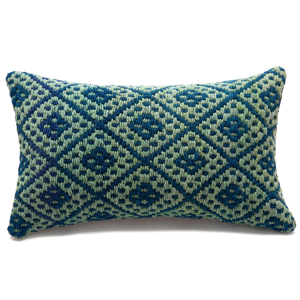 Decorative pillow with blue and green geometric pattern on a white background