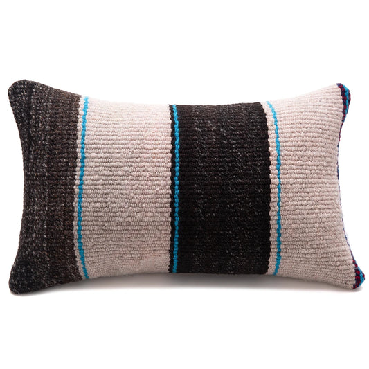 A rectangular woven throw pillow with a striped pattern of black, beige, and gray, accented by thin vertical blue stripes, shown on a plain white background.