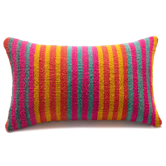A rectangular throw pillow with a vibrant vertical striped pattern in pink, yellow, orange, and teal, set against a plain white background.