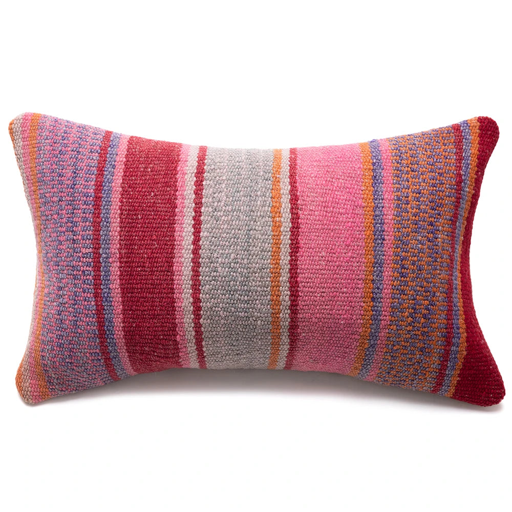 A rectangular woven throw pillow with vertical stripes in pink, red, orange, blue, and gray on a white background.