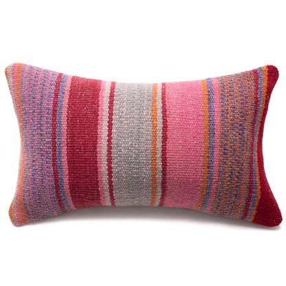 A rectangular woven throw pillow with vertical stripes in pink, red, orange, blue, and gray on a white background.