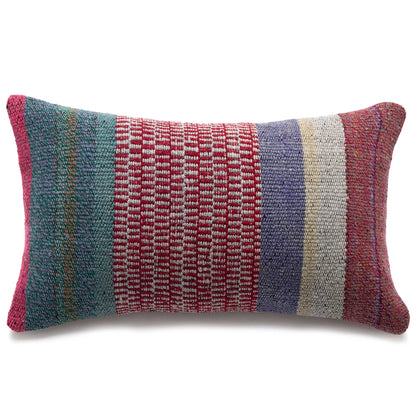 A rectangular woven throw pillow with vertical stripes in teal, red, lavender, cream, and rust red, shown on a plain white background.