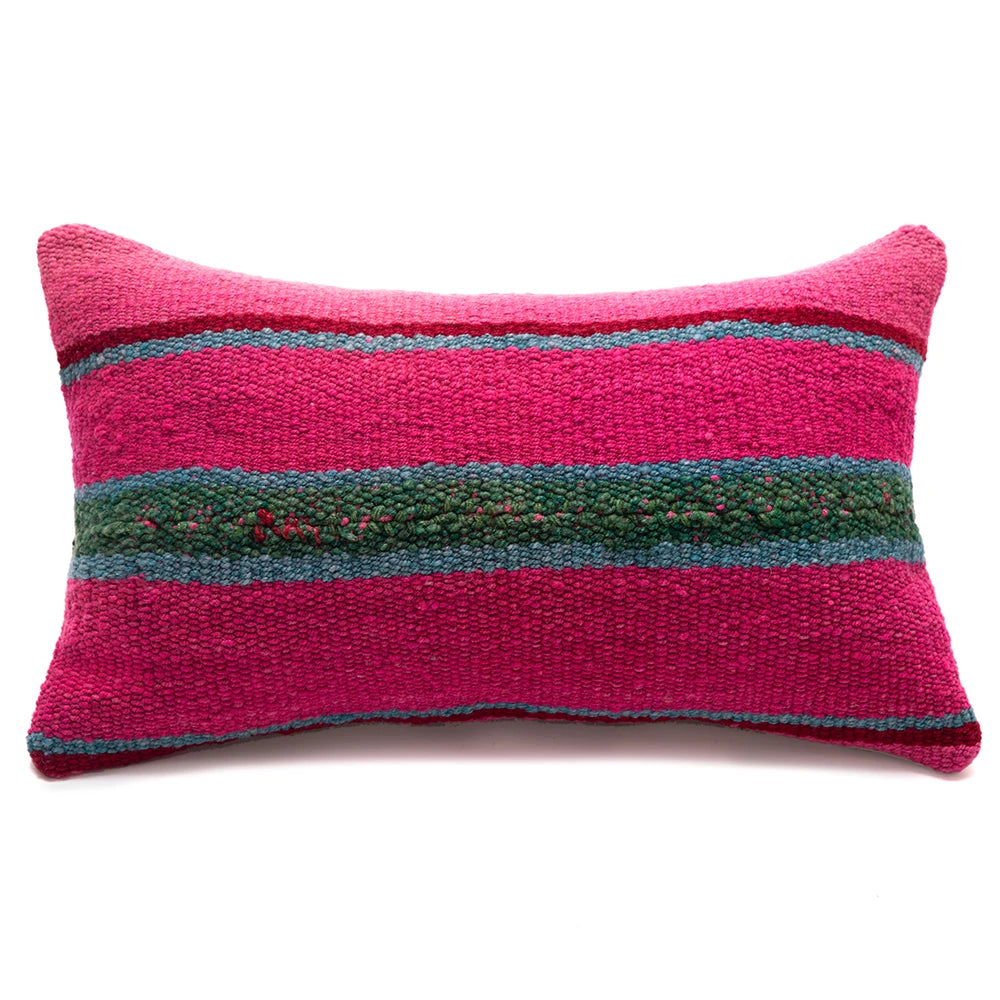 Pink pillow with green and blue stripes on a white background
