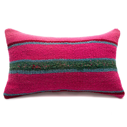 Pink pillow with green and blue stripes on a white background
