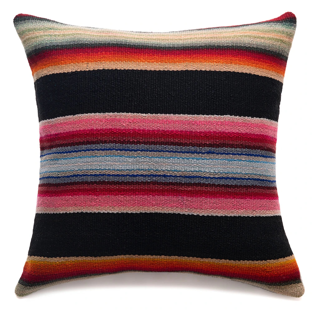 A square throw pillow featuring a colorful horizontal striped pattern inspired by a serape blanket, set against a plain white background.