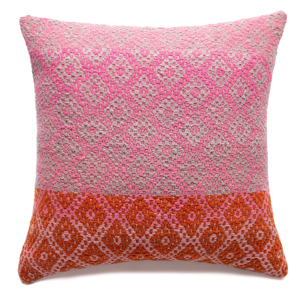 Decorative pillow with pink and orange pattern on a white background