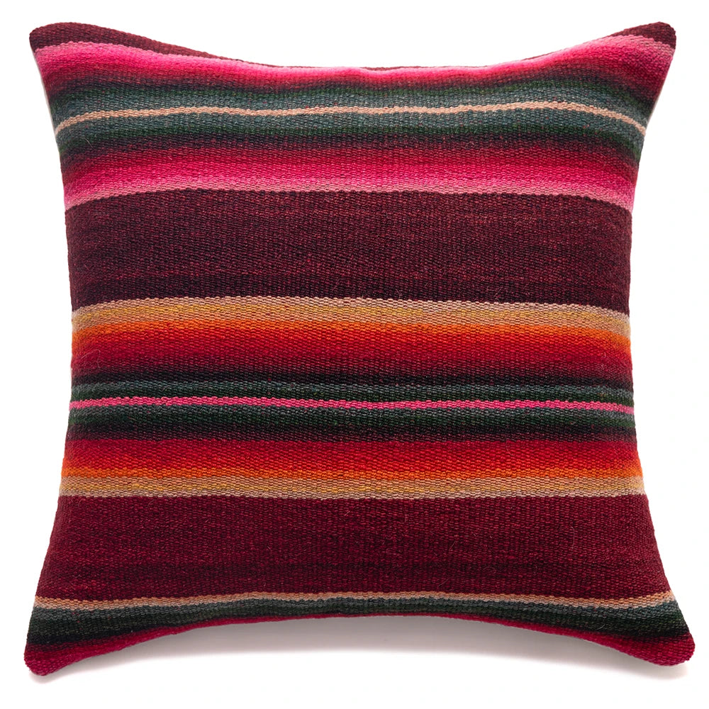 Striped pillow with red, pink, and orange colors on a white background