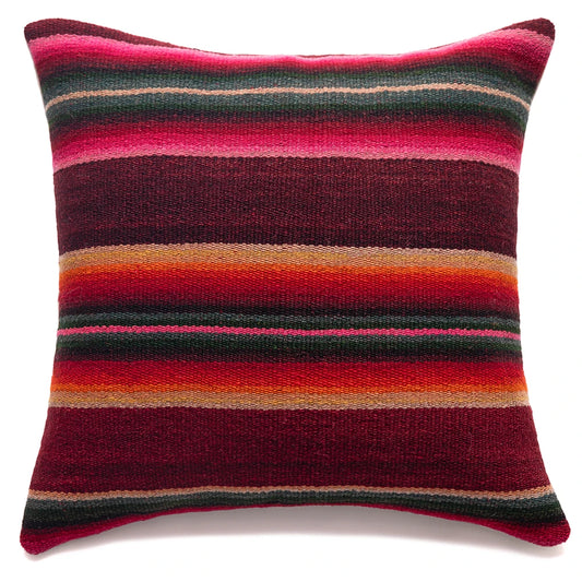 Striped pillow with red, pink, and orange colors on a white background