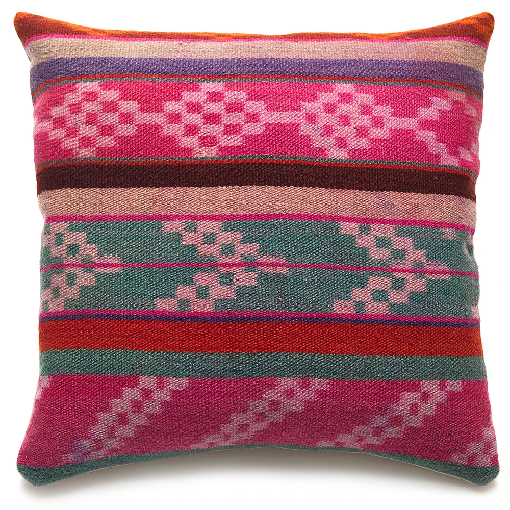 Multicolored patterned pillow with geometric design on a white background
