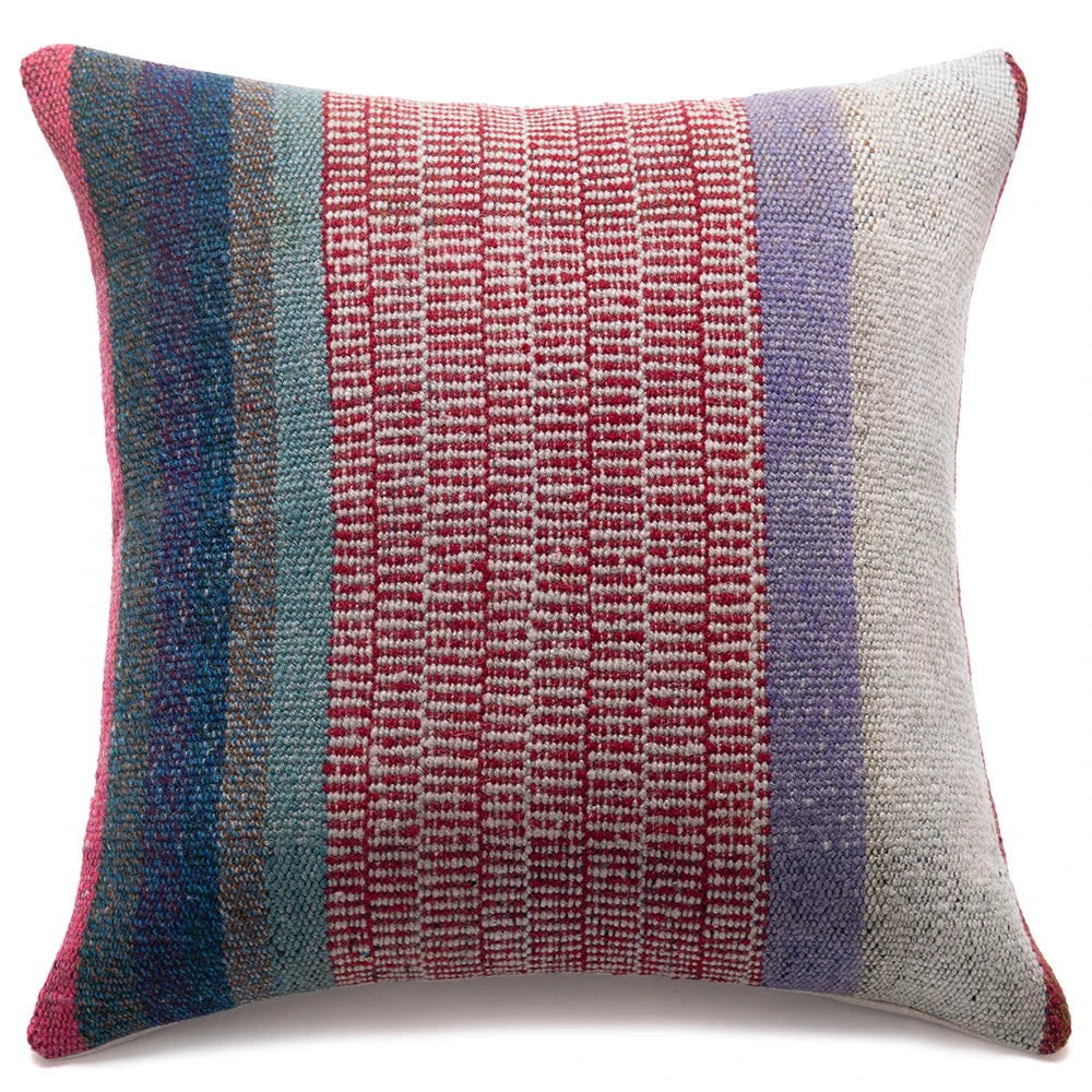 A square woven throw pillow featuring vertical stripes of red, teal, blue, lavender, and off-white, set against a plain white background.