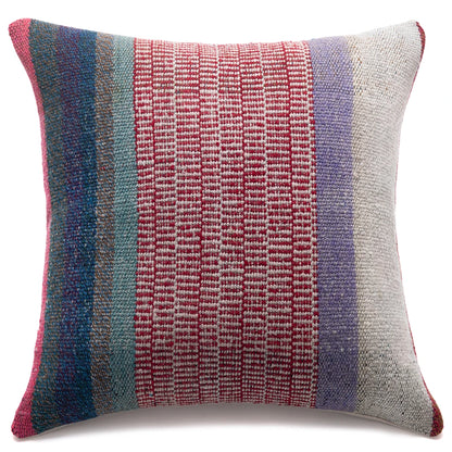A square woven throw pillow featuring vertical stripes of red, teal, blue, lavender, and off-white, set against a plain white background.