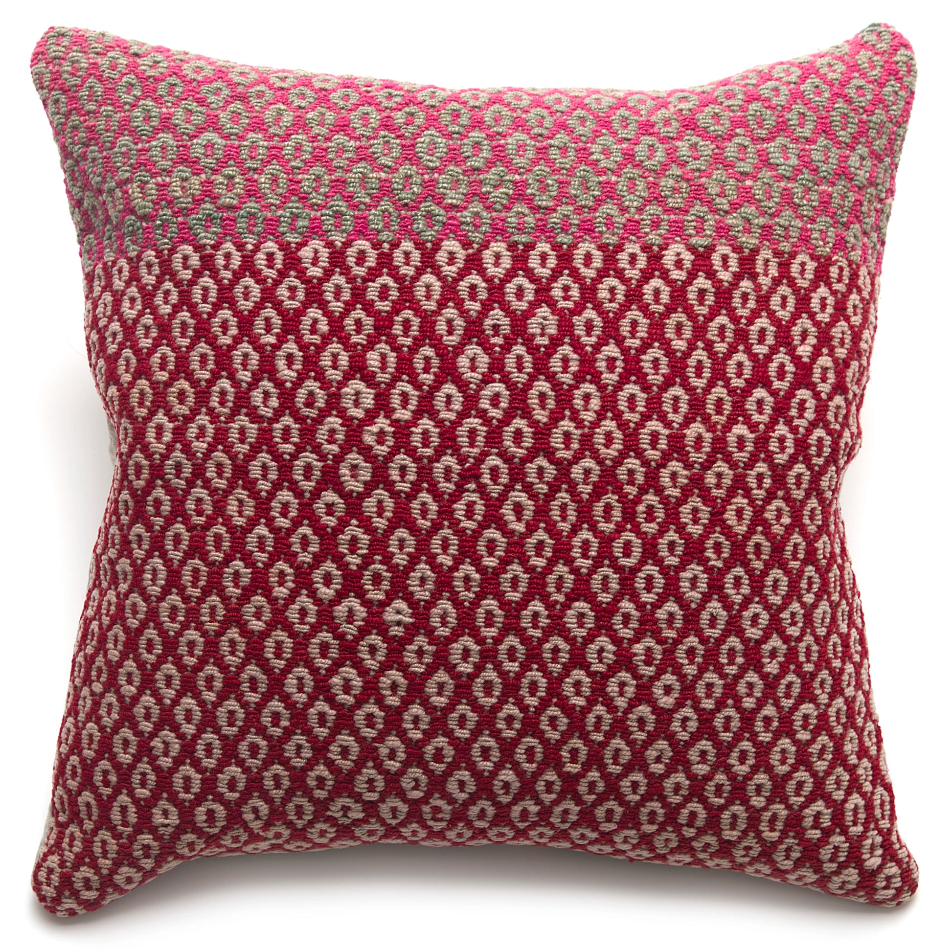 Patterned pillow with pink and beige design on a white background
