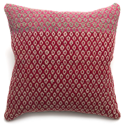 Patterned pillow with pink and beige design on a white background