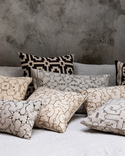 Intiearth_peruvian_shipibo_hand_painted_textiles_Pillows_bold_nogal_black_and_white_bed_grey_wall_ss24