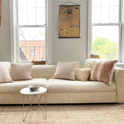 Neutral Pillows on cream sofa in living room 