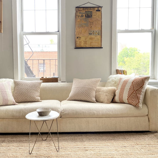 Neutral Pillows on cream sofa in living room 