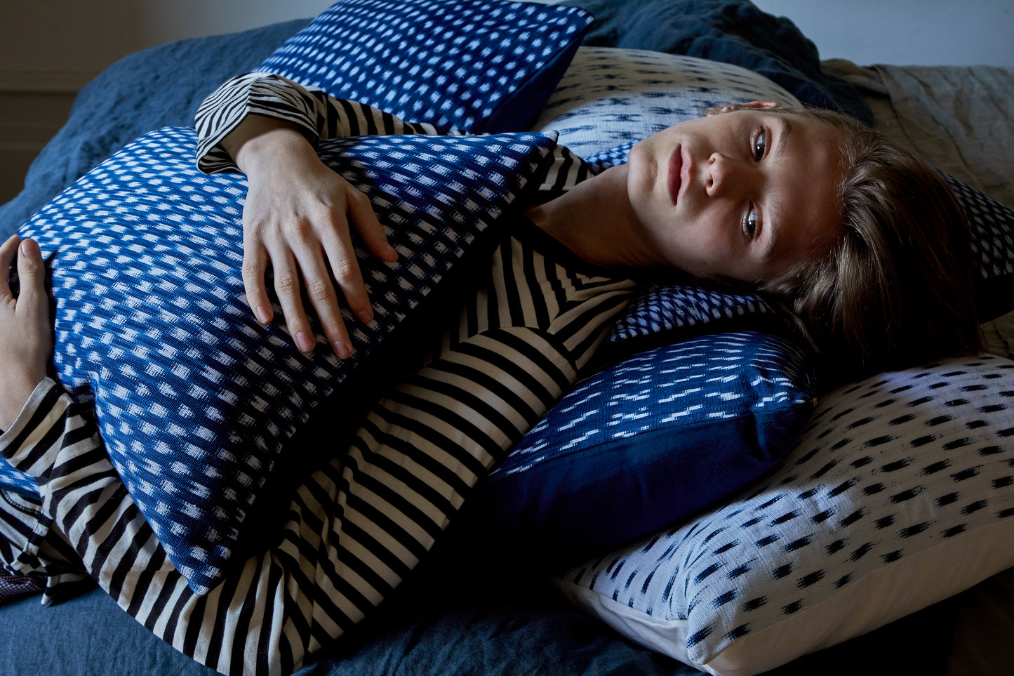 intiearth-peruvian-ikat-pillows-on-bed-with-man.jpg